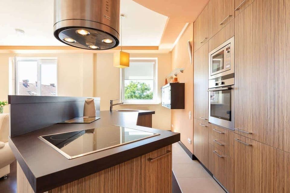 Kitchenette with oven and refrigerator. 