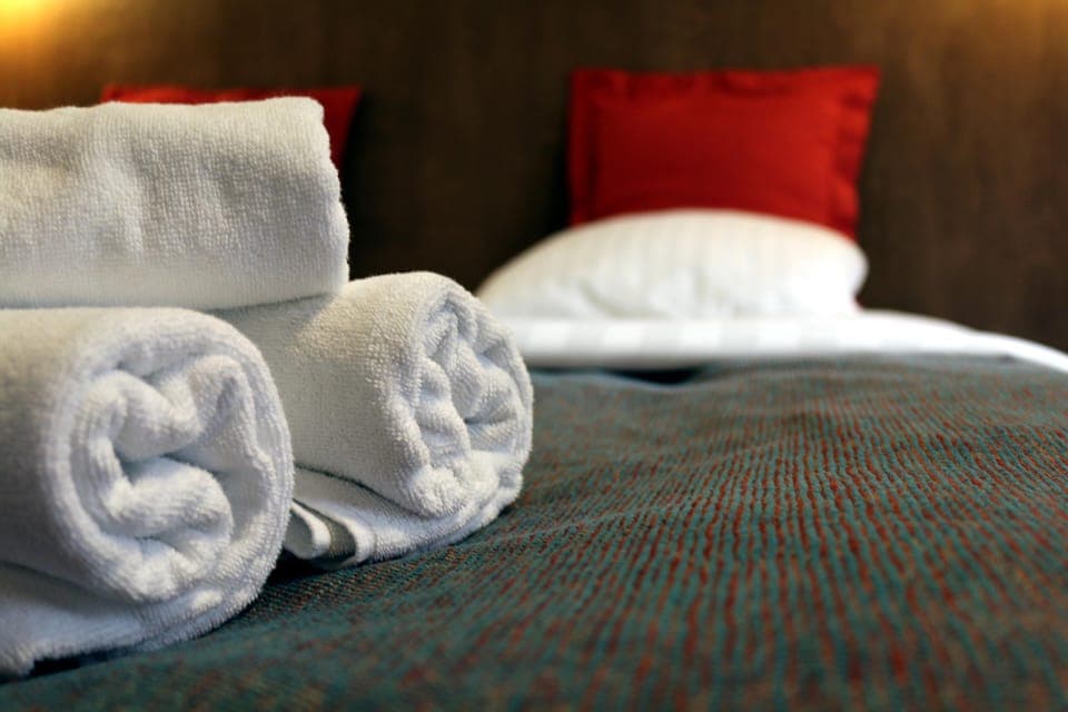 Hypo-allergenic bedding, desk, laptop workspace, blackout drapes