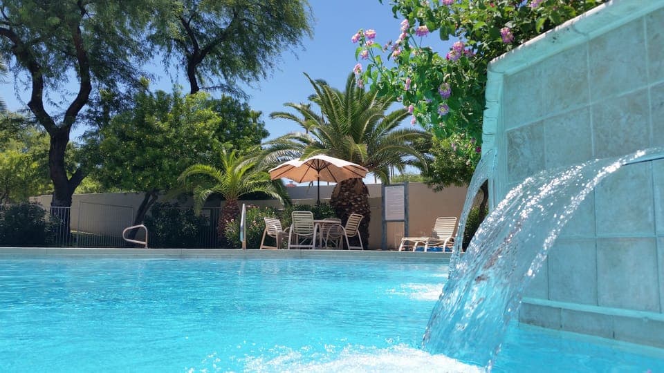 Tropical pool and Spa area with community grills.