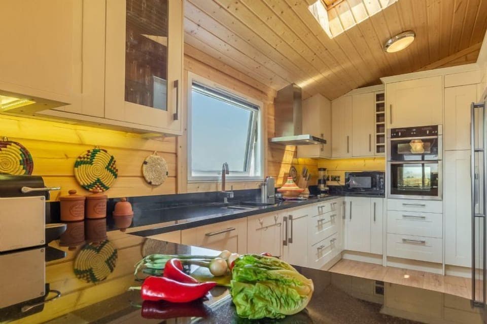 Ground floor: Kitchen with an electric oven, hob,  fridge/freezer and dishwasher