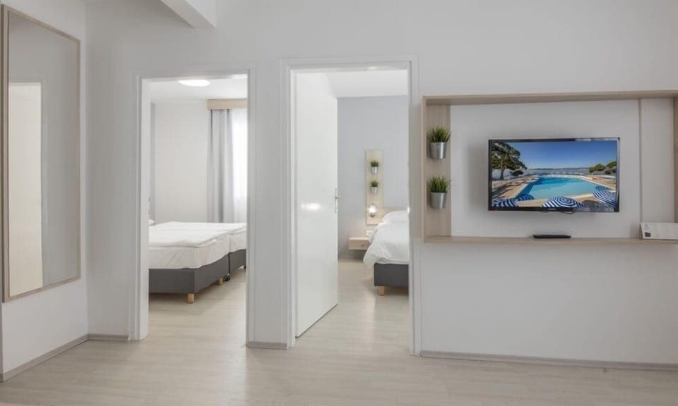 Family Room with seaside balcony | Premium bedding, in-room safe, desk, free WiFi