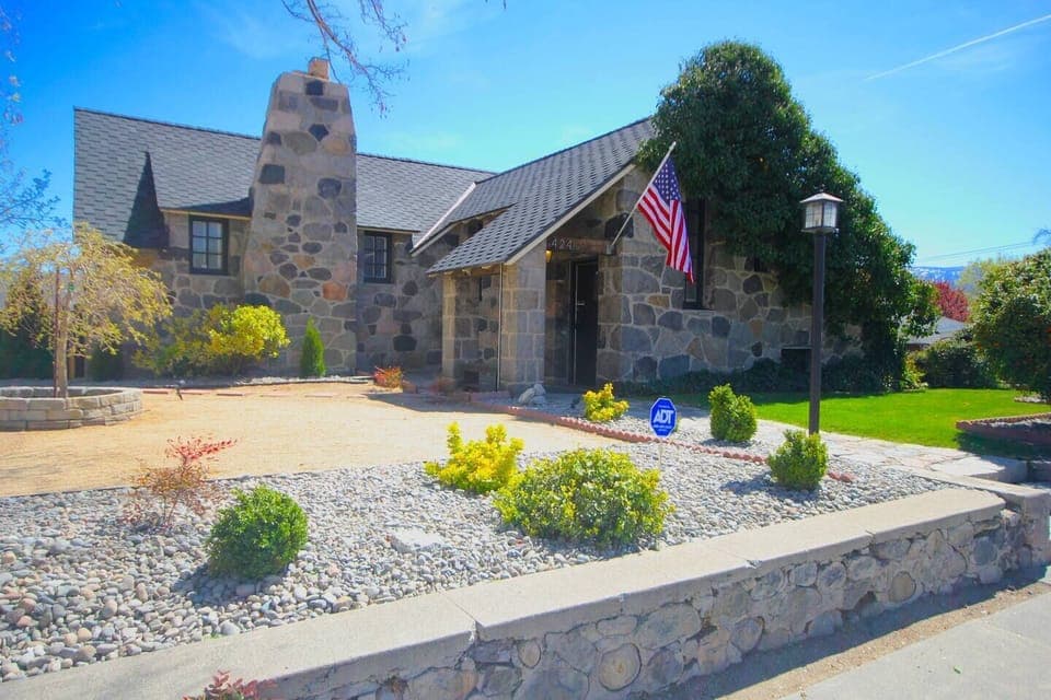 The spacious yard provides plenty of room for the kids to play.#stayrenostonehouse