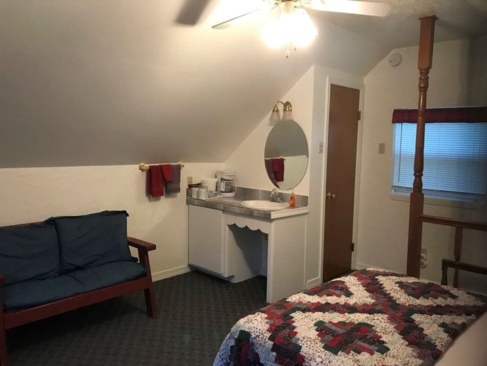 Upstairs has a sink and vanity as well as a small sitting area.