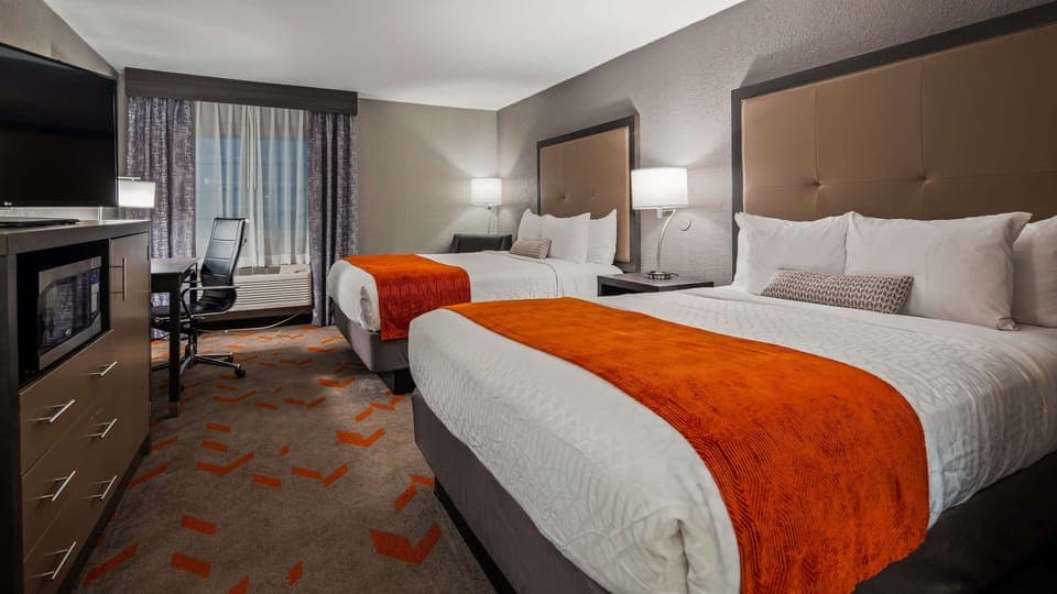 Hypo-allergenic bedding, desk, laptop workspace, blackout drapes