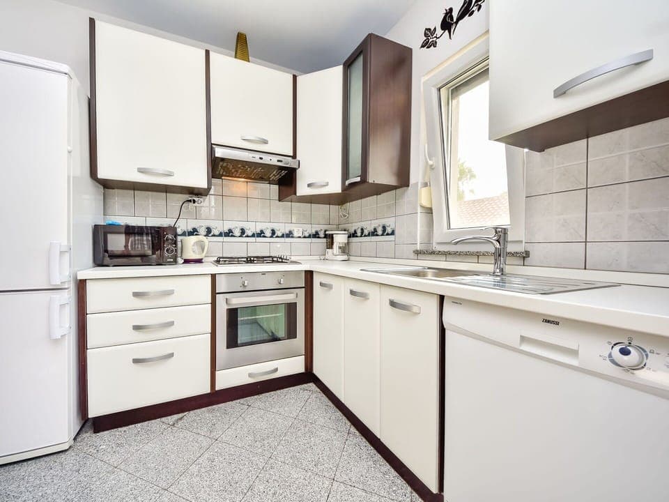 Cabinetry, Room, Countertop, Property, Kitchen, Furniture, Interior Design, Major Appliance, Building, Yellow