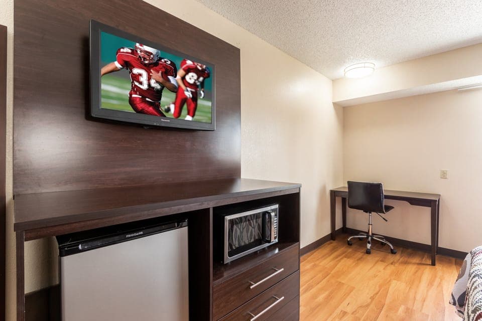 Desk, laptop workspace, iron/ironing board, free cribs/infant beds