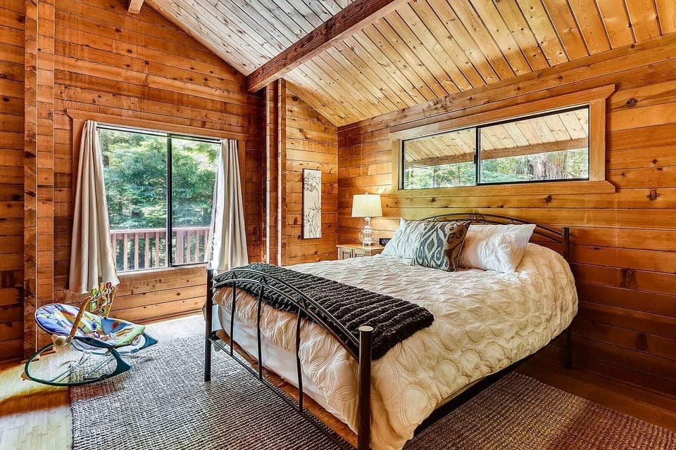 Natural light, all wood construction in the upstairs master bedroom with queen bed,