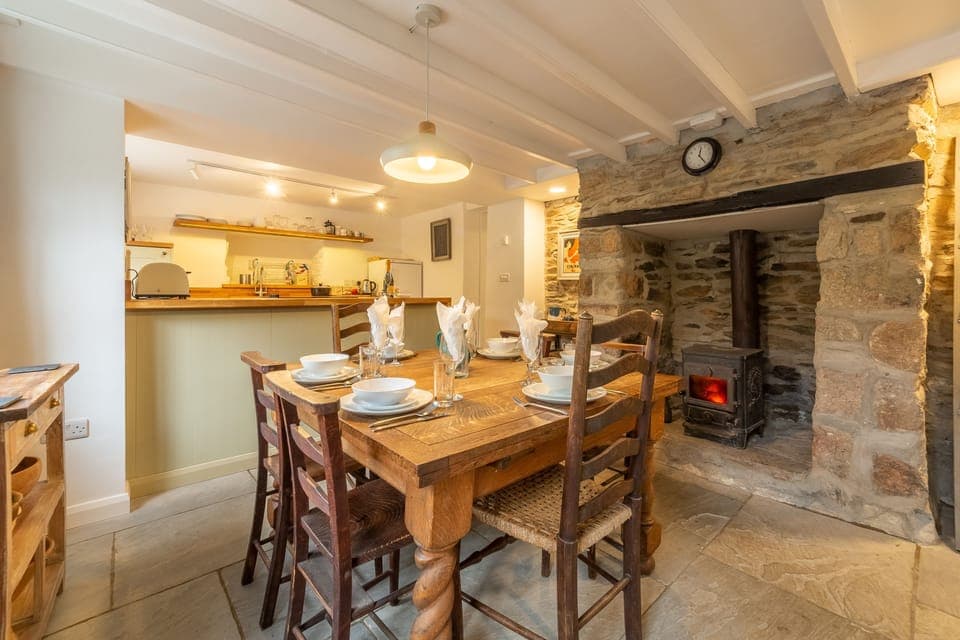 Ground floor: Dining area with table and a inglenook fireplace with wood burning stove