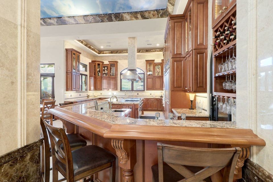 Gourmet kitchen with granite counters, wine bar & custom cabinets. Entertain!