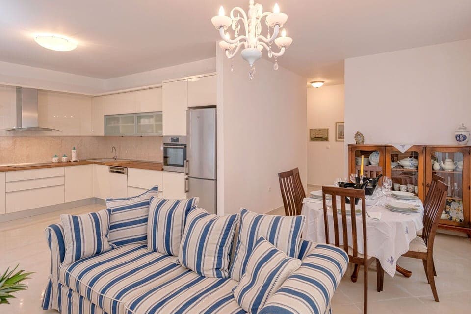 living room with fully equipped kitchen including all appliances