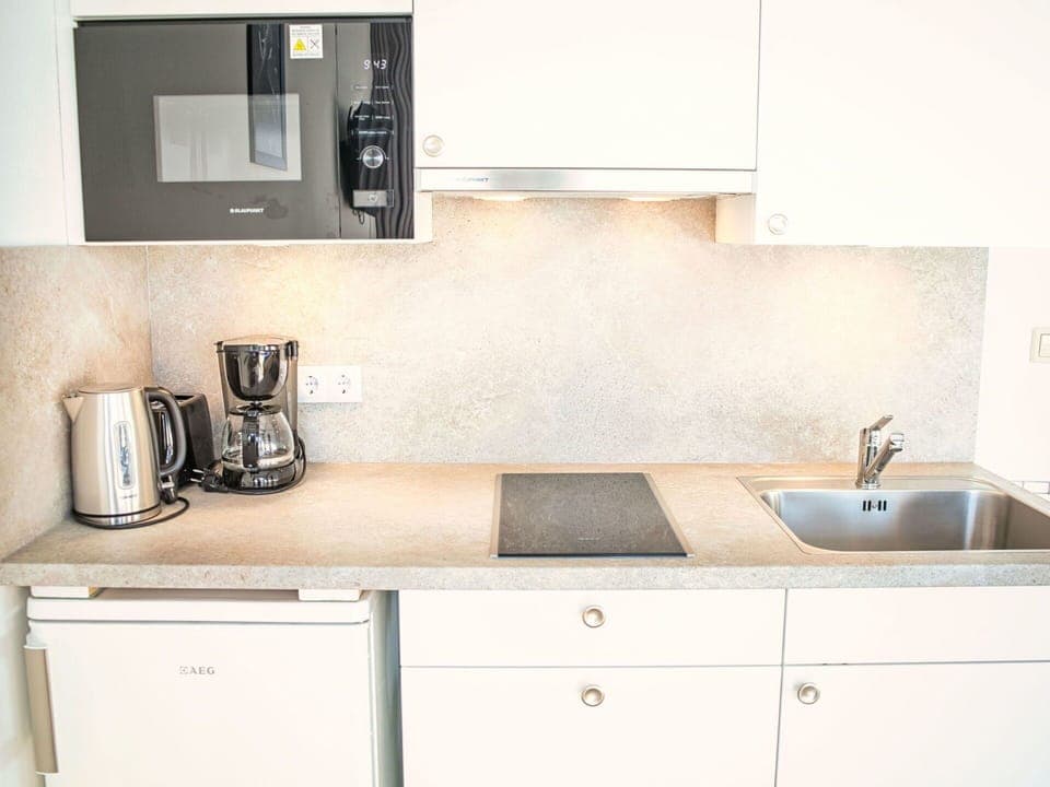 Countertop, Kitchen, Cabinetry, Kitchen Appliance, Kitchen Sink, Interior Design, Plumbing Fixture, Sink, Tap, Major Appliance