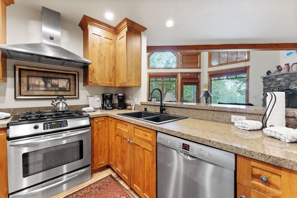 Full size kitchen with granite countertops new hardwood flooring and stainless steel appliances throughout.