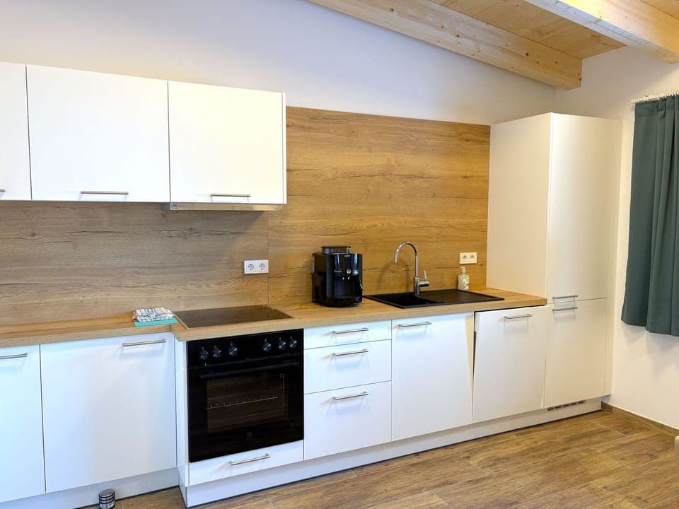 Flooring, Countertop, Wood, Interior Design, Kitchen, Cabinetry, Floor, Kitchen Appliance, Furniture, Major Appliance