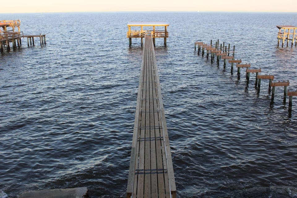 View of pier from balcony. Concrete pad on left of pier is for launching kayaks.