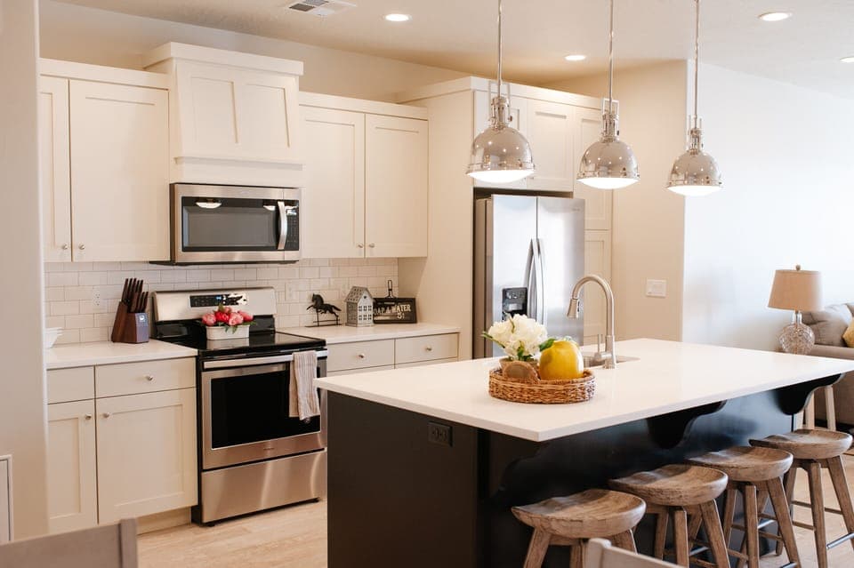 Fully equipped kitchen featuring island seating and stainless appliances.