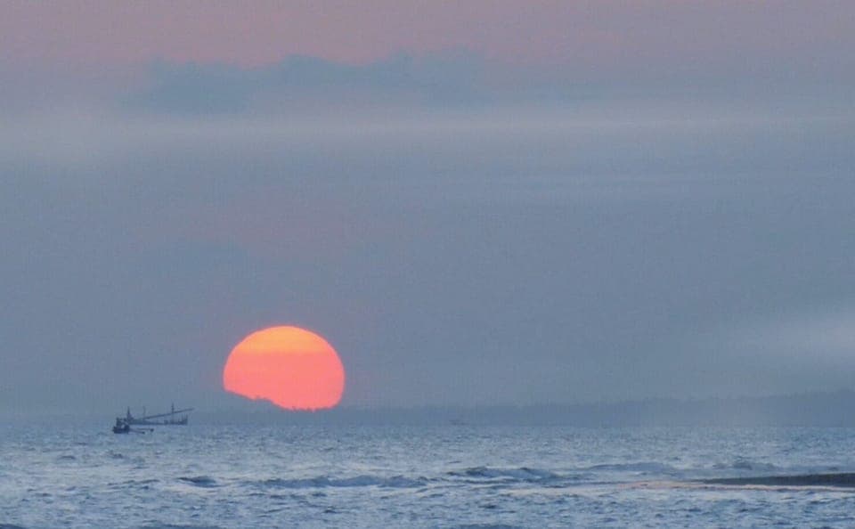 On the beach, black sand, beach towels, beach bar