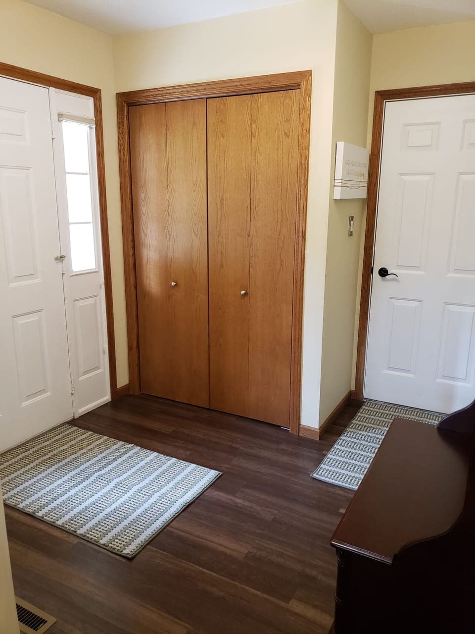 Foyer with door to garage as well as front door that goes to backyard. 