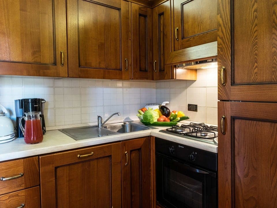 Countertop, Cabinetry, Room, Kitchen, Furniture, Property, Lighting, Interior Design, Wood Stain, Kitchen Stove