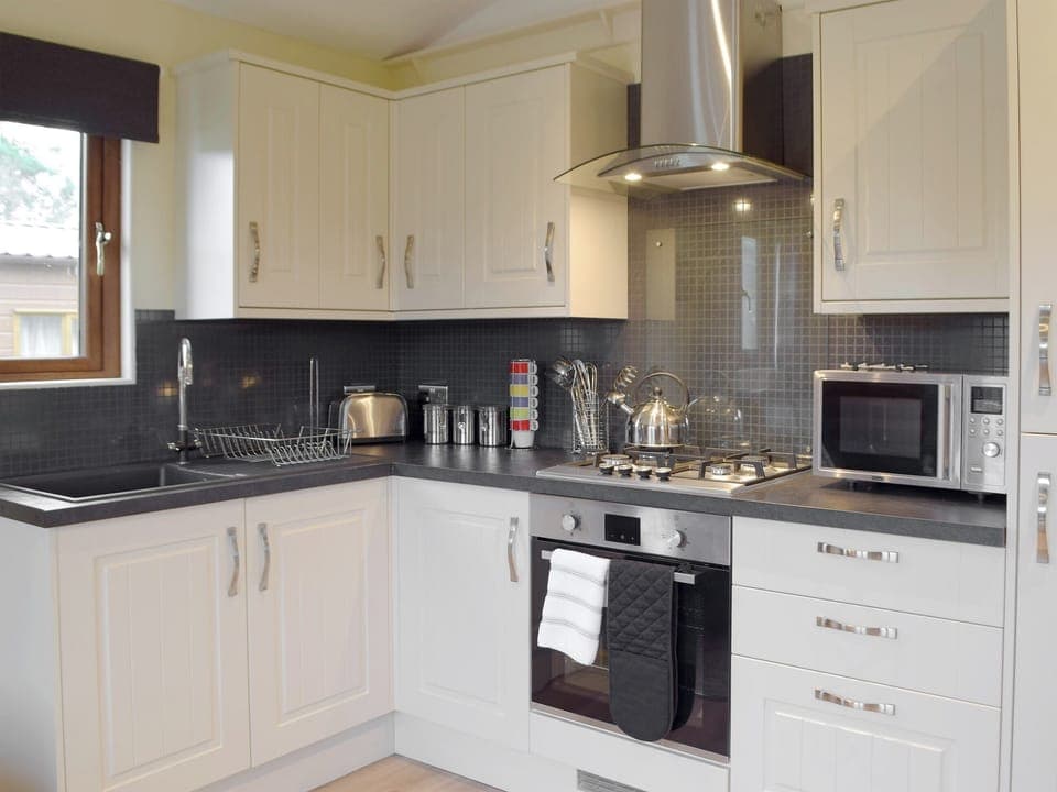 Well equipped kitchen area | Herons Log Cabin, Rosebush
