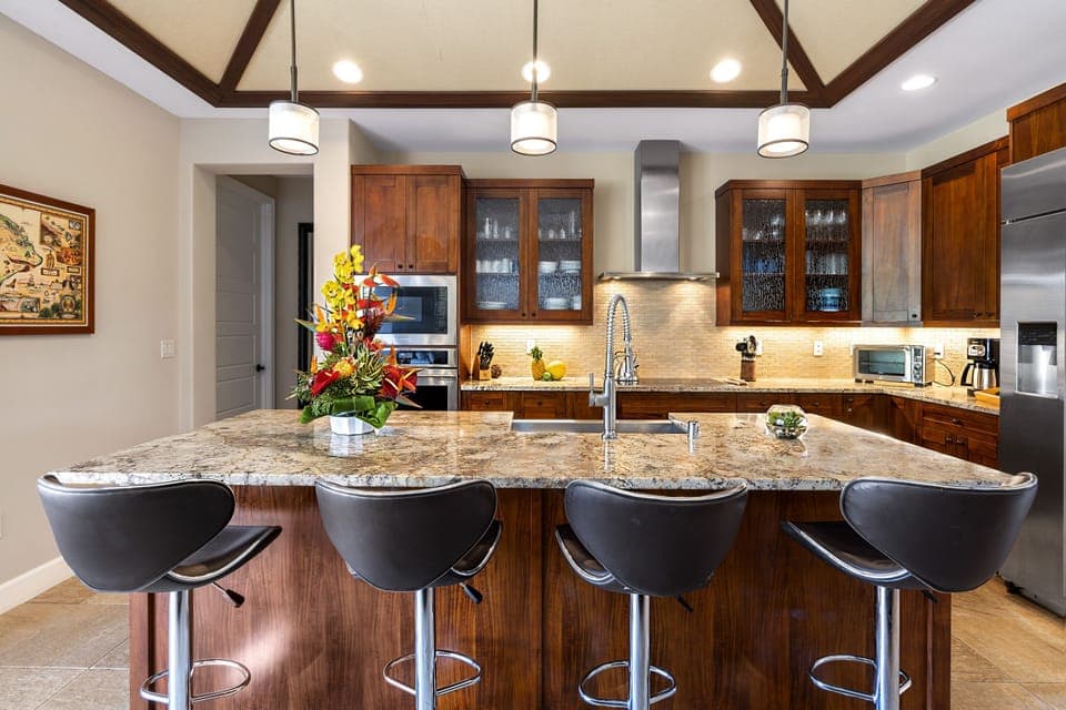 Spacious gourmet kitchen island at Kona Blue Vacations Holua Kai, perfect for casual bites or group meals.