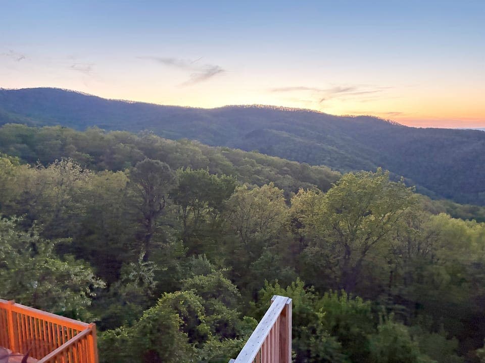 The view is the main event: rolling ridges, open sky, and total mountain calm.