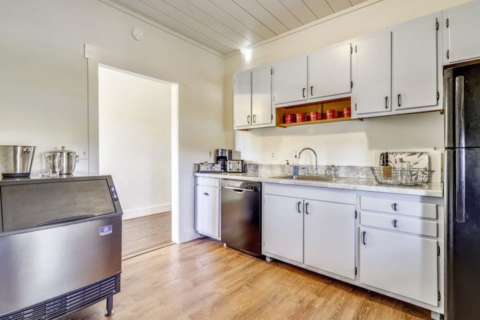 Guest kitchen features a fridge, dishwasher, stove, oven and microwave.