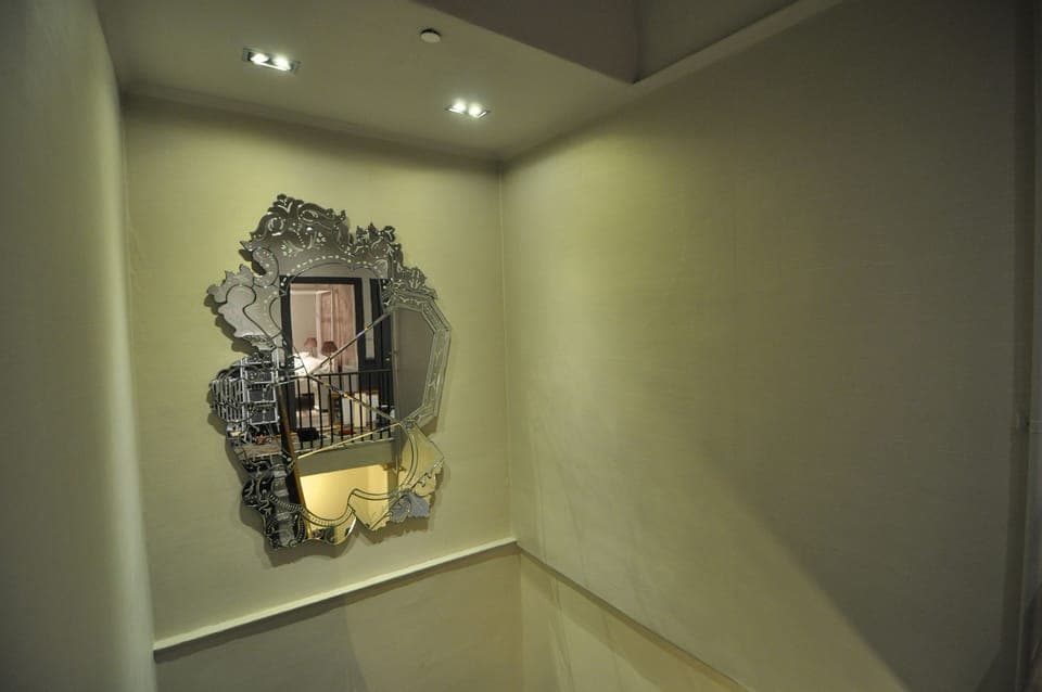 stairwell with large venetian mirror