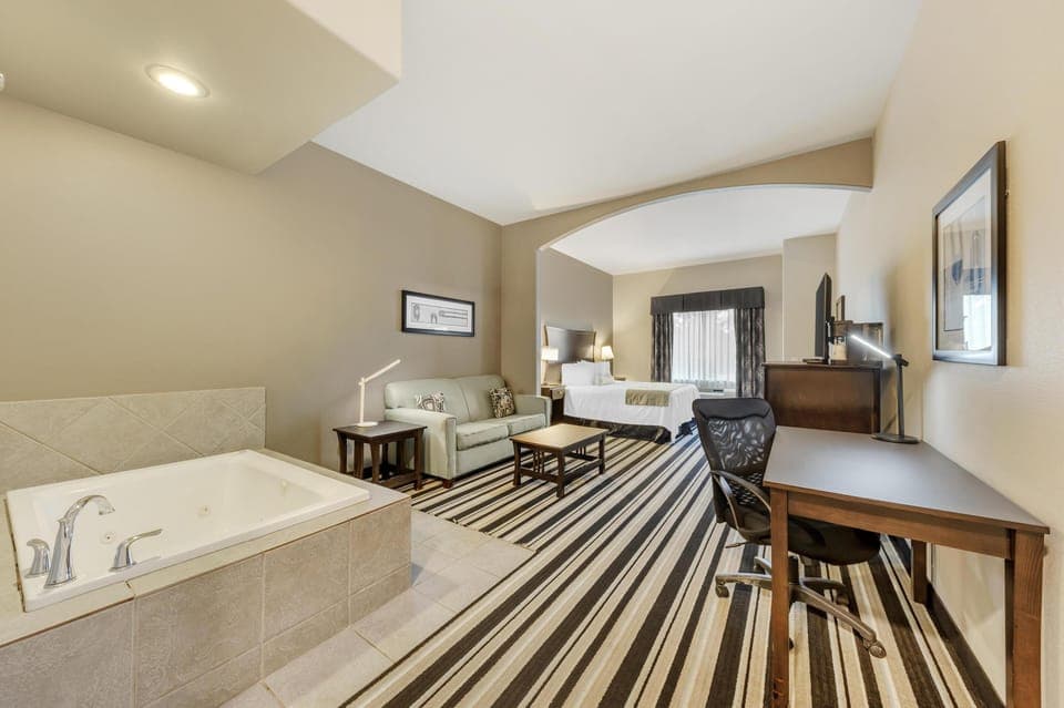 Suite, 1 King Bed, Non Smoking, Jetted Tub (Larger Room;with Sofabed) | Premium bedding, pillowtop beds, desk, laptop workspace