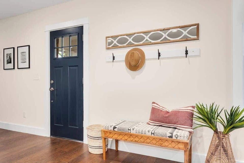 Our gorgeous entryway is complete with a cozy bench and hangers for your coats, hats and bags.