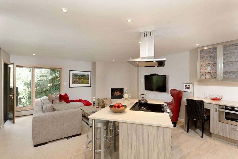 This bright and airy corner unit has a wonderful wooded feel as it is surrounded by Aspen and Spruce trees.