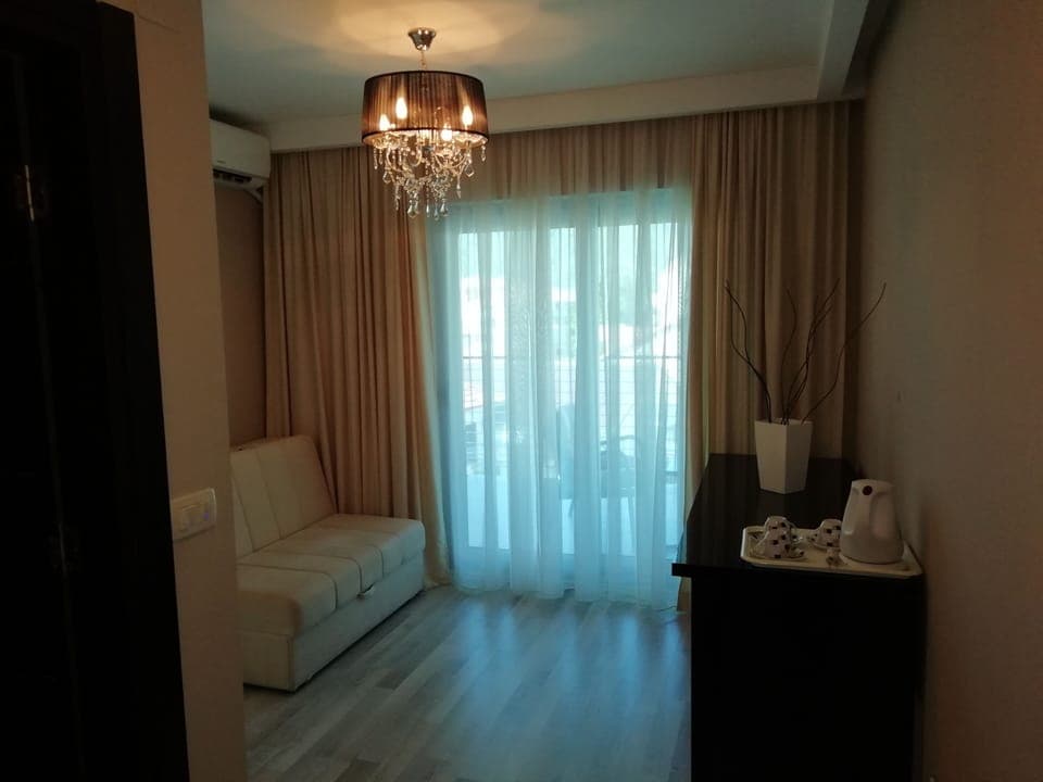 Comfort Triple Room | Living area | LCD TV