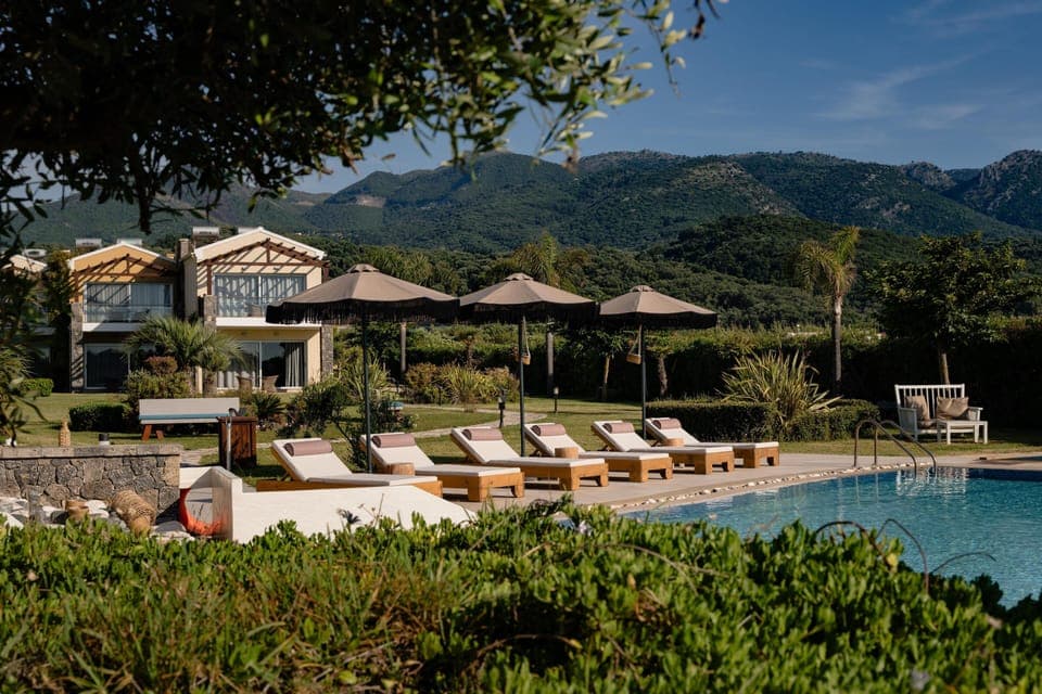 Seasonal outdoor pool, open 10:00 AM to 6:00 PM, pool umbrellas