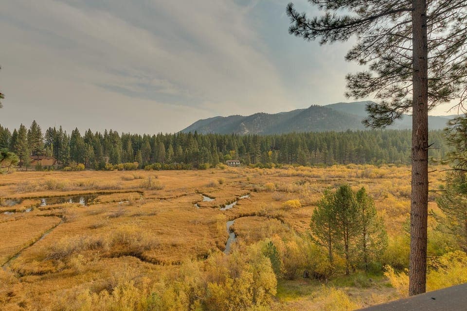 - Scenic meadow and mountain peak views  
- Tall pines and winding stream backdrop  
- Tahoe vacation rental with nature scenery