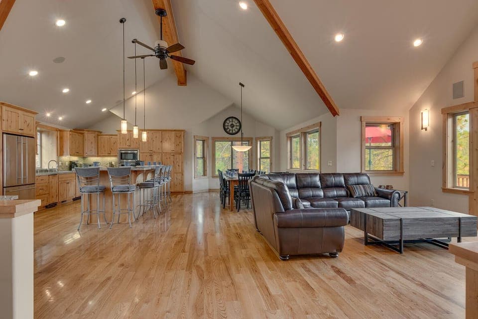 - Open floor plan with vaulted ceilings  
- Kitchen, dining, and living space combined  
- Tahoe cabin rental with modern family design