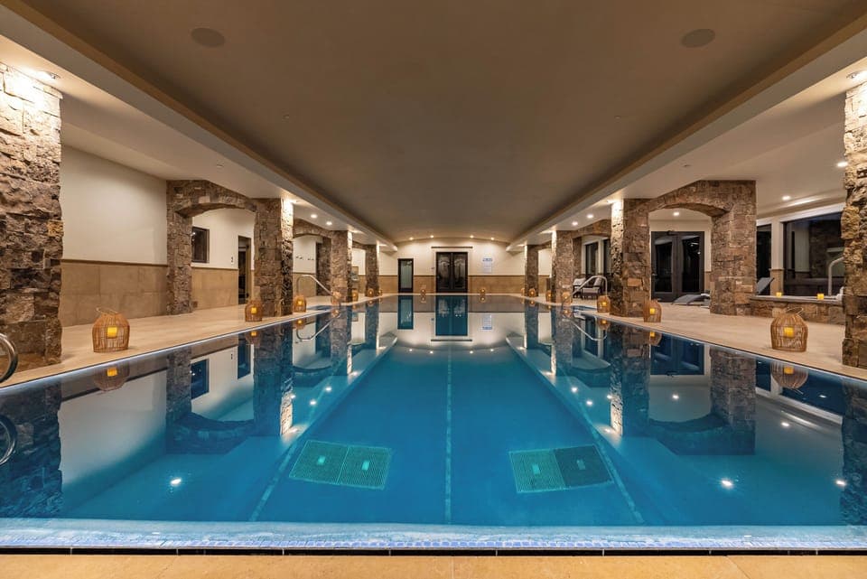 Indoor 20x60 foot pool located on the lower level with views of Lone Peak