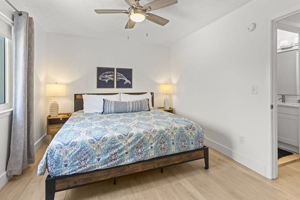 Drift off to sleep in your serene bedroom with coastal touches and a gentle ceiling fan.