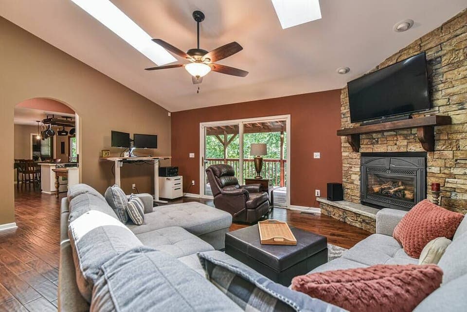 Living room with plenty of seating to enjoy the flat screen TV & gas log fireplace.

Notice the laptop workspace in the background! Two monitors for you to use plus a printer!
