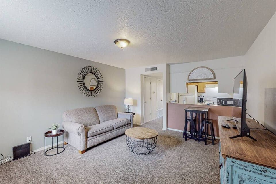 Living room area with small kitchen table nook