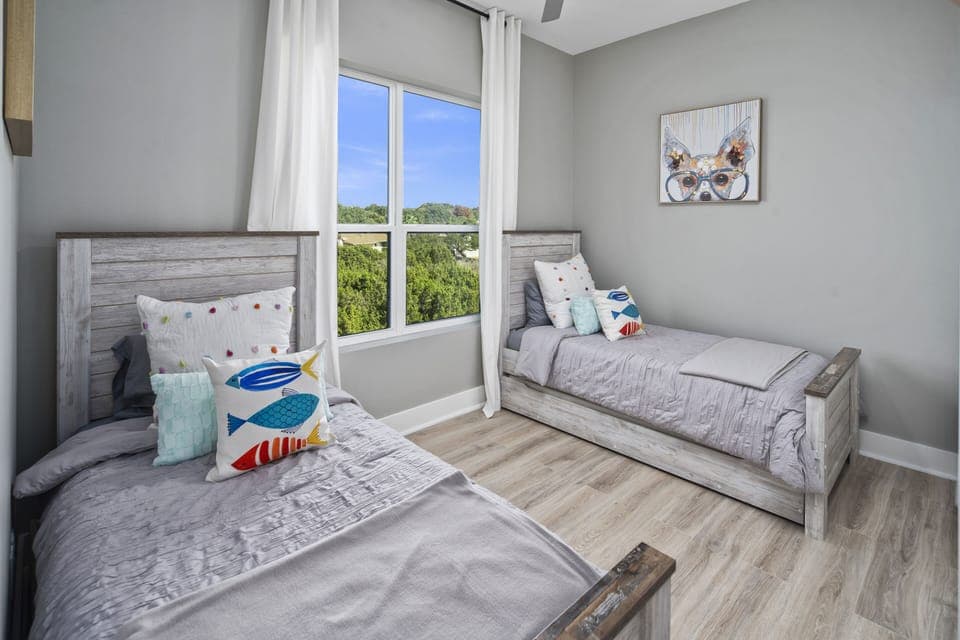 Guest room with 2 twin beds + two pull out twin trundles with sheets below.