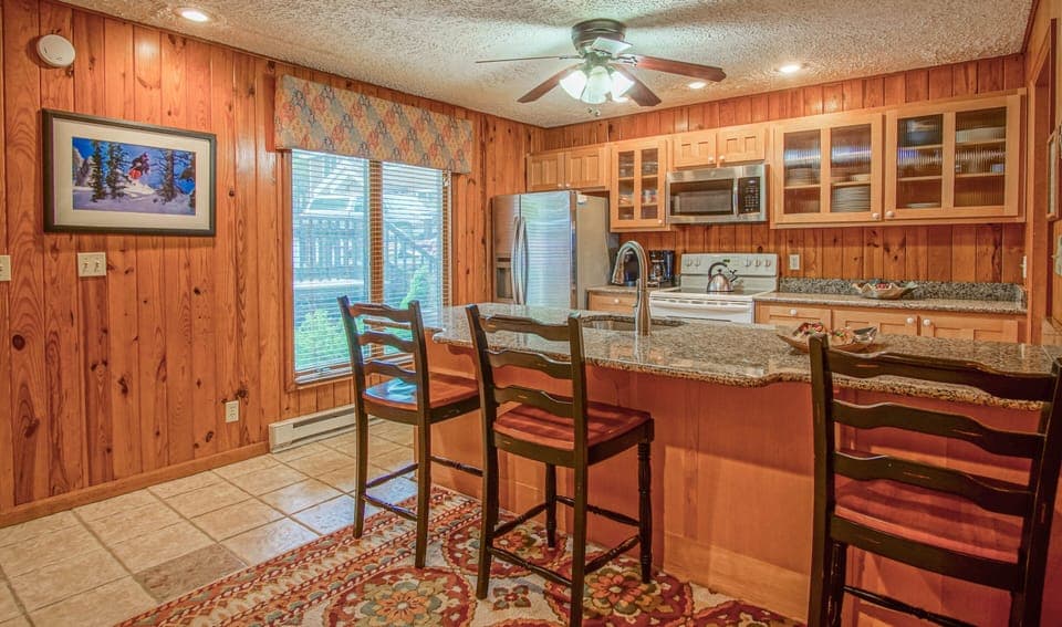 The kitchen is located on the 2nd level. The kitchen bar has seating for 3.