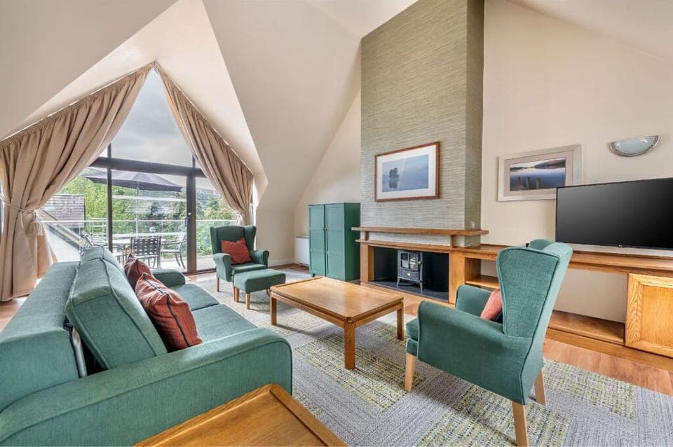 Inviting living area with vaulted ceilings and a cozy seating arrangement.