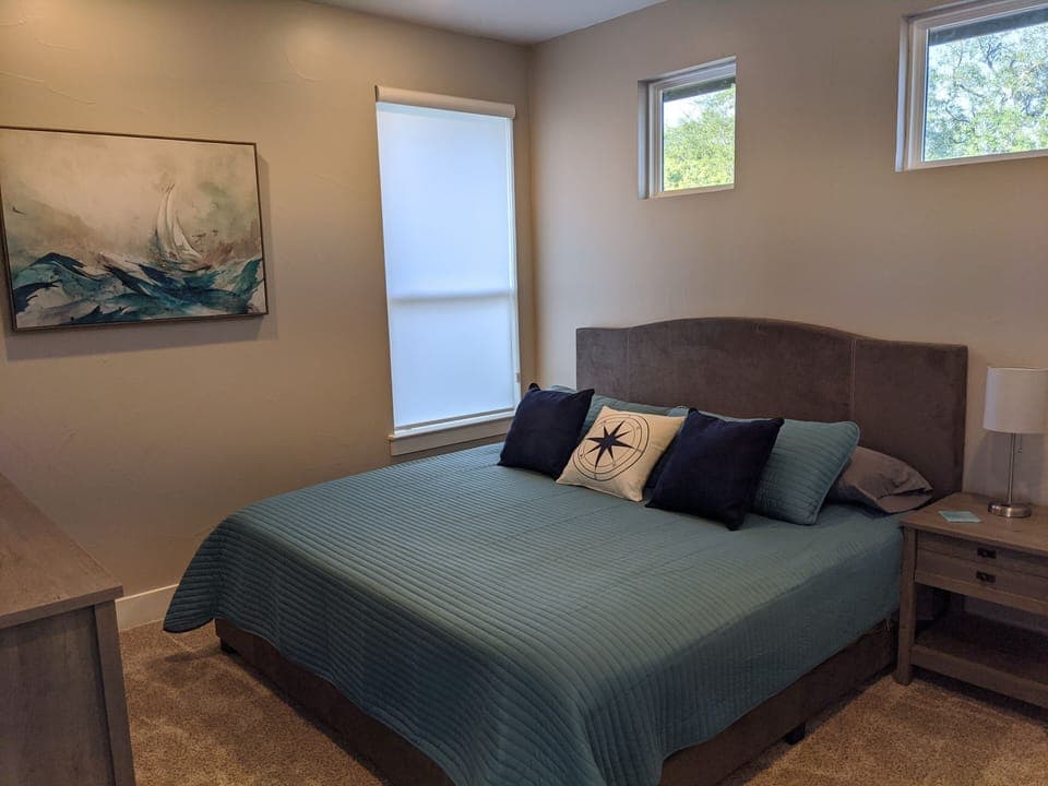 secondary bedroom with king bed, 50" Roku TV, private sink area