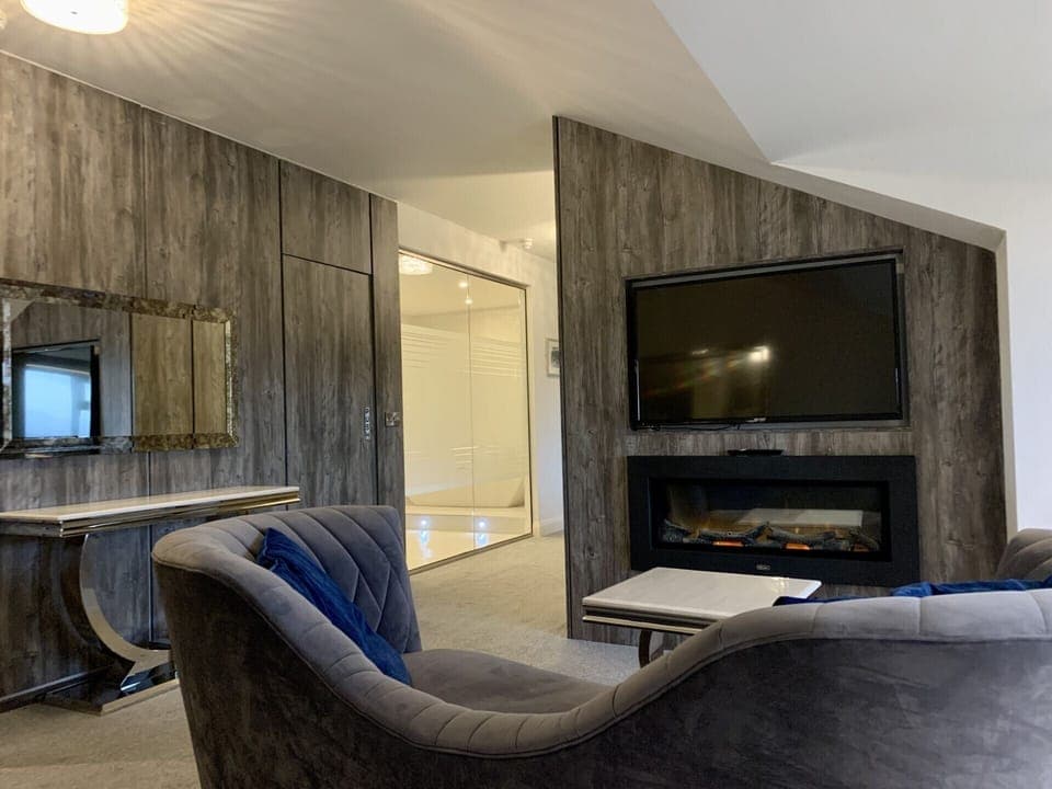 Deluxe Suite | Living area | 32-inch TV with digital channels