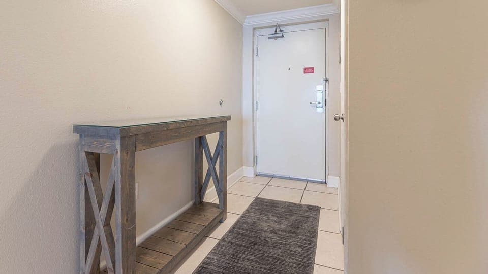 Welcoming entryway featuring a stylish console table and soft lighting, setting an inviting tone for your beach vacation