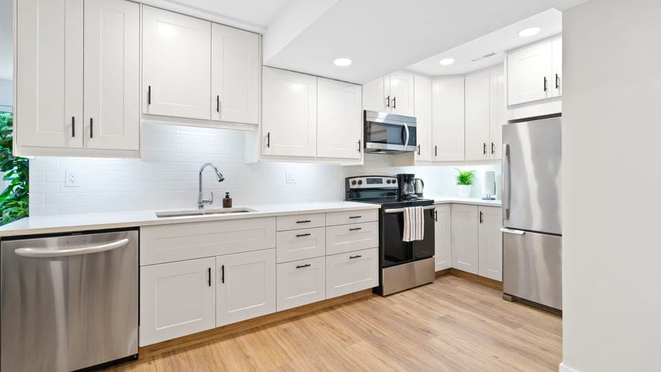 Kitchen: quartz countertops, dishwasher, stove, microwave, and refrigerator.