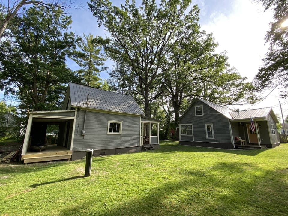 Boat house on the left and main house on the right and secluded back yard