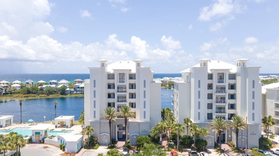 Modern beachfront resort buildings overlook pristine turquoise waters and tropical lagoons in this stunning Caribbean destination.