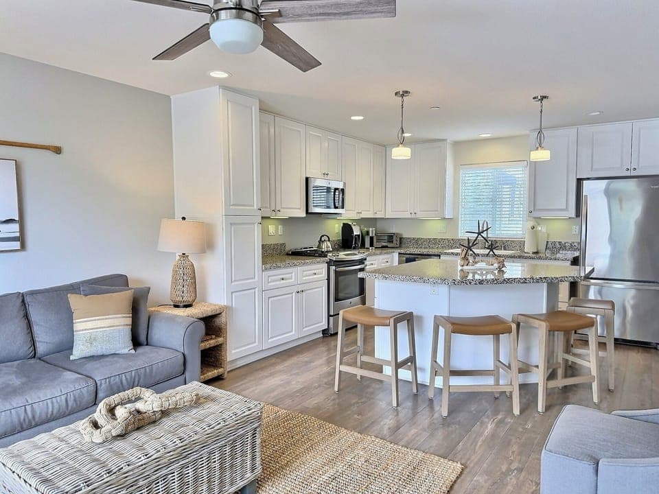 A bright, open living space flows into a chef-grade kitchen, complete with high-end appliances — the perfect blend of style, comfort, and coastal charm.
