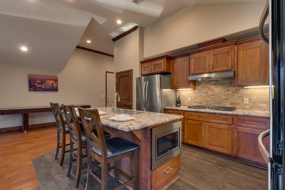 - Modern kitchen with granite counters  
- Stainless steel appliances throughout  
- Breakfast bar with stylish seating