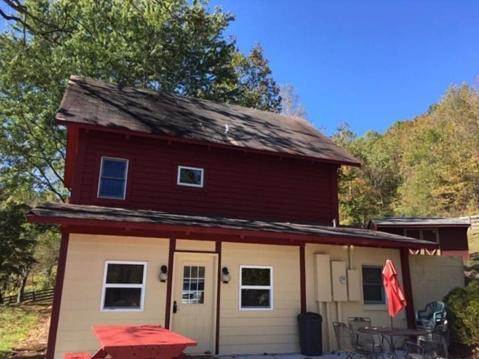 Front patio has picnic table and patio table with chairs.